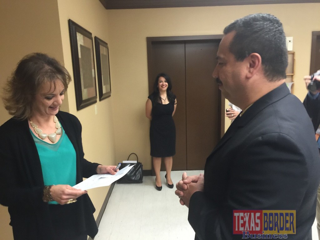 Dr. Ambrosio Hernandez filing for mayor in Pharr Texas. Hilda Pedraza city secretary receiving filing documents to become officially a mayoral candidate.